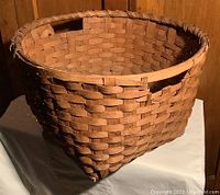 Front side view showing weave pattern and minor damage on the rim.