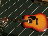 Full view of the guitar showing the sunburst finish, fretboard, and headstock