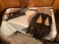 Overview of bagpipe parts and horsehair sporran with belt laid out on cloth