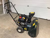 Front quarter view showing handle, engine and housing