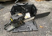 Full view of Craftsman chainsaw placed inside the black plastic carrying case showing saw and blade details
