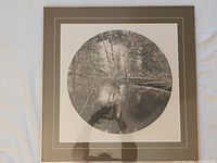 Framed black and white circular fine art print by George Raab with reflections of trees and water in nature.
