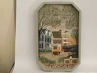 Front view of folk art painting on tray showing New England town scene with houses, horses, trees, ship and lamp post.