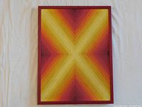 Full frontal view of framed geometric gradient painting on white surface