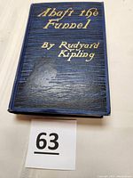 Front cover of the book showing the title 'Abaft the Funnel' and author Rudyard Kipling embossed in gold on a dark blue textured background.