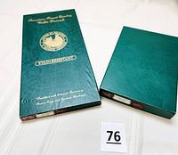 Two green original boxes labeled 'American Finest Quality Table Damask' and 'Stain-Resistant', showing packaging of tablecloth and napkin set.