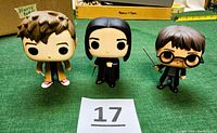 Set of three Funko Pop vinyl figures including Harry Potter, Severus Snape, and the 10th Doctor from Doctor Who on green background with inventory card.