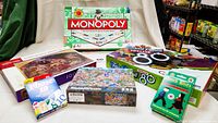 Full set of family games and puzzles including Monopoly, Trivial Pursuit Totally 80s, Dutch Blitz, Phase 10, and two jigsaw puzzles.