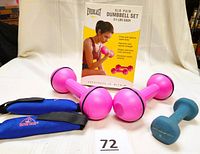 Photo showing the full lot: Everlast pink dumbbell pair, Water Gear blue wrist weights, Prospirit blue 2 lb barbell, and original Everlast packaging.