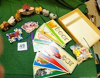 Full lot including Noah's Ark wooden animals arranged in semicircle, 8 picture boards laid out with visible words like 'bear' and 'car', a wooden storage box, and a bag of letters