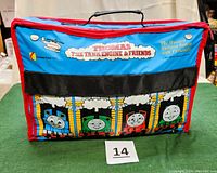 Front view of the blue and red carrying case with Thomas The Tank Engine & Friends graphics on the front pocket.