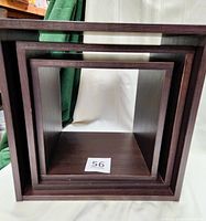 Photo of three nested cube shelves in dark brown wood finish, showing inner and outer edges.