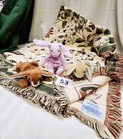 Vintage Williamsburg Dogwood floral Afghan spread out with three plush bunny toys on top including two Ty Beanie Babies and one Kellytoy Beanpal.