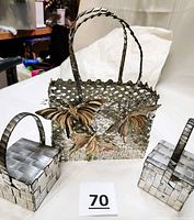 Large woven metallic basket with three butterflies and two handles showing vintage patina