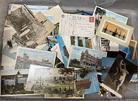 Collection of assorted postcards and ephemera showing views of buildings and scenic locations, including color and black and white prints