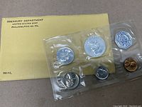 Photo of 1961 proof coins in sealed plastic sleeve with original yellow Treasury Department envelope.