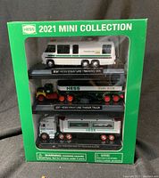Front view of the boxed set showing all three model trucks: Training Van, Tanker Truck, and Toy Truck with Racers.