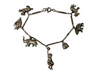 Full view of antique animal charm bracelet featuring six different charms on a linked chain with clasp.