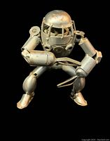 Front view of the handmade metal steampunk robot figure showing its assembled structure from bolts and nuts with visible corrosion.