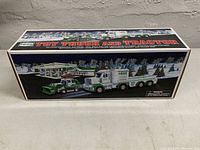 Front of the box showing the Hess Toy Truck and Tractor 2013 edition in original packaging, showcasing the truck and tractor images with winter scene background.