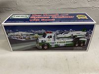 Front side of the Hess Toy Truck and Space Cruiser box showing the truck and rocket launcher in snowy setting with branding and celebration logo.