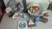 Wide view of the beach and nautical themed decor items together on a surface