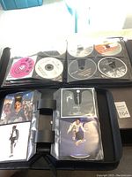 Photo showing one binder with multiple Michael Jackson CDs including various album covers and disc designs.