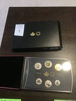 Photo of specimen set in plastic case with six coins and black display box