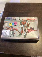 Front view of boxed Macross VF-1J Valkyrie model kit with artwork showing the toy's 3 transformation forms.
