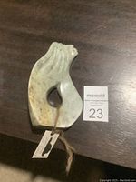 Front view of the soapstone sculpture showing the stylized figure with flowing hair and central opening.