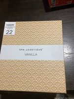 Box exterior with Spa Luxetique Vanilla branding in beige and white pattern.