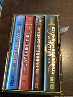 Spine view of the four hardcover books showing titles and author's name in a row