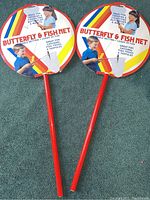 Two new butterfly and fish nets displayed top side up, showing colorful circular packaging and red handles