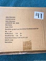 Photo of cardboard box packaging showing product and shipping label for Shelter Logic 10x10 white side panel for canopy/tent.