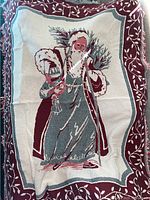 Full view of one side of the blanket showing St Nicholas dressed in a traditional robe with burgundy and white leaf border.