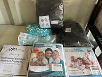 Photo of various mattress covers and stuffing materials in packaging showing waterproof mattress protectors and stuffing for DIY projects.