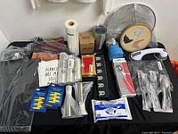 Wide view of all kitchen accessories and tools arranged on table