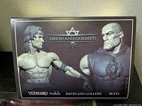 Box cover showing David and Goliath busts side by side, showcasing muscular, detailed sculptures in monochrome tones.