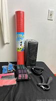Full view of yoga mat, yoga blocks, resistance bands, sweat bands, hand grips.