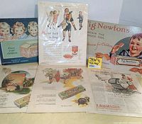 Lot showing six vintage food advertising pieces, including 2 metal Nabisco 1996 National Biscuit Company wall art items and 4 antique paper on board Saturday Evening Post magazine ads from 1927, 1928, and 1931 with children and product themes.