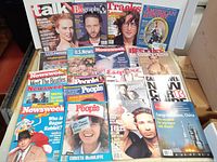 Photo showing 18 vintage magazines displayed on table, covering headlines on space, celebrities, music, and news. Titles include People, Newsweek, Esquire, Men's Health, Cosmopolitan, and others.