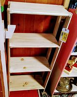 Front and angled view of 4-shelf wooden bookcase showing natural wood finish and construction details.