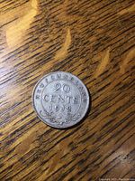 Reverse side of the 1912 Newfoundland 20 cent coin showing denomination, year and decorative elements.