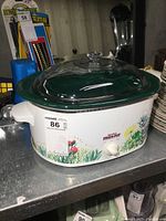 Front angle of Rival Crock-Pot slow cooker showing floral decoration and control dial.