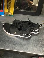 Side view of black Nautica runners showing logo and sole detail