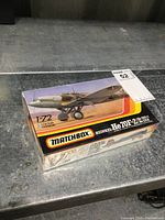 Photo of sealed Matchbox model kit box featuring color illustration of the Heinkel He 70F-2 airplane.
