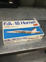 Box top of F/A-18 Hornet model showing the airplane artwork and model details.