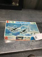 Box of 1/72 scale Twin Mustang F-82 model kit by Hasegawa showing front with aircraft artwork and product details.