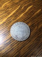 Obverse side of the 1918 Newfoundland 50 cent coin showing denomination and year.