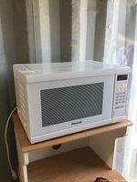 Front angle view showing the main door with a window and control panel with buttons.